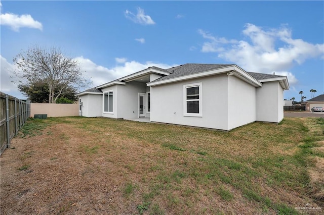 rear view of property with a yard