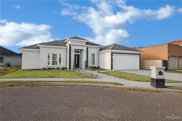 prairie-style home featuring a garage and a front yard