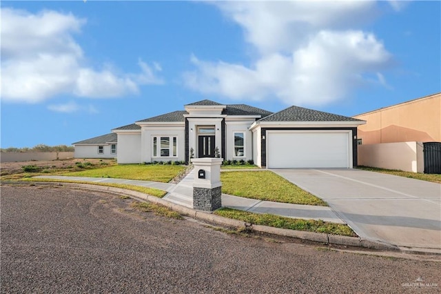 view of front facade featuring a garage and a front lawn