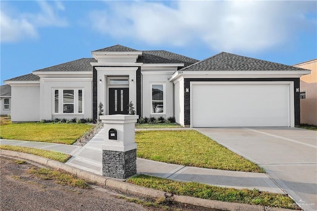 prairie-style home featuring a garage and a front lawn