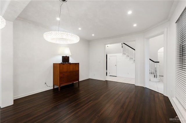 interior space with wood-type flooring, ornamental molding, and a chandelier