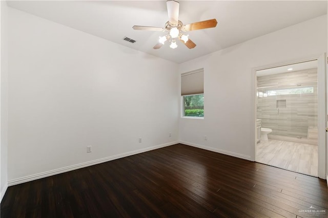 unfurnished bedroom with hardwood / wood-style floors, ceiling fan, and connected bathroom