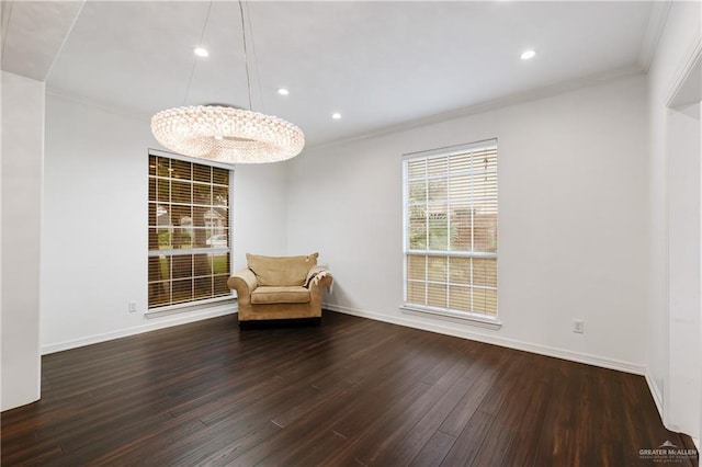 unfurnished room with dark hardwood / wood-style flooring, crown molding, and an inviting chandelier