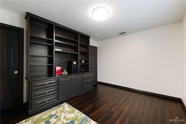 bedroom with dark hardwood / wood-style floors