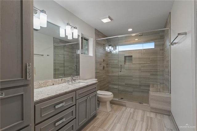 bathroom with vanity, toilet, and walk in shower