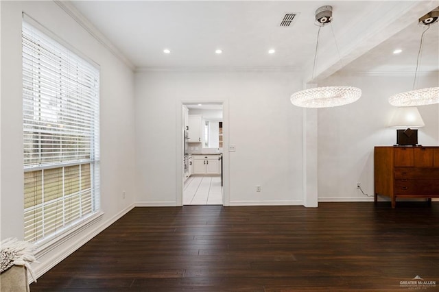 unfurnished living room with dark hardwood / wood-style flooring and crown molding