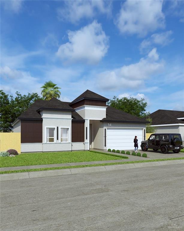 view of front of house with a garage, driveway, fence, a front lawn, and stucco siding