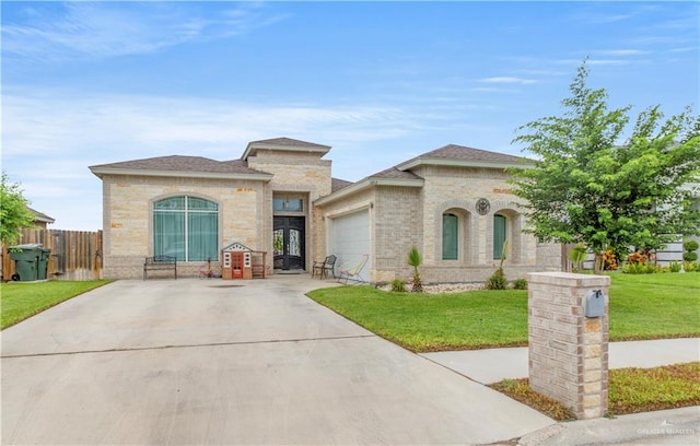 view of front of property featuring a front lawn and a garage