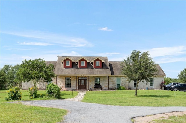 cape cod home with a front lawn