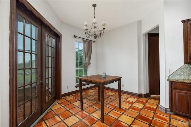 unfurnished dining area featuring tile patterned flooring, french doors, and a chandelier