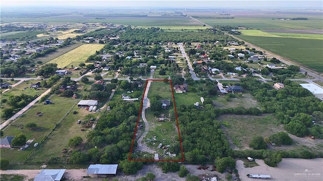 aerial view of property's location with property parcel outlined, rural landscape, and large plots for crops