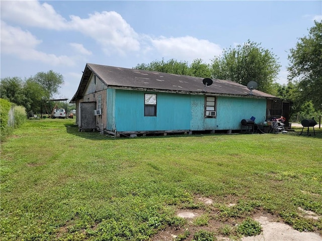 view of side of home featuring a lawn and cooling unit