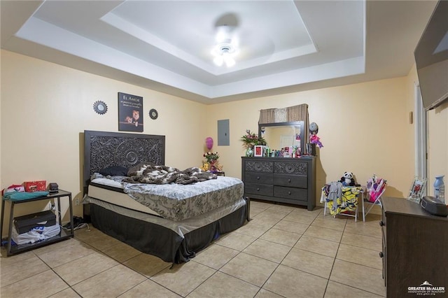 tiled bedroom featuring a raised ceiling and electric panel