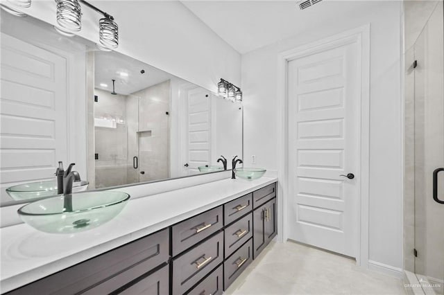 bathroom with vanity and a shower with shower door