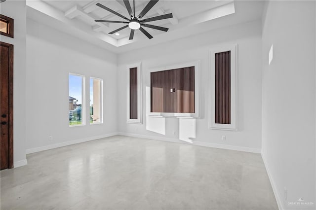 spare room featuring coffered ceiling, beam ceiling, and ceiling fan