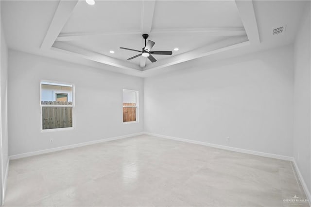 spare room with a raised ceiling and ceiling fan