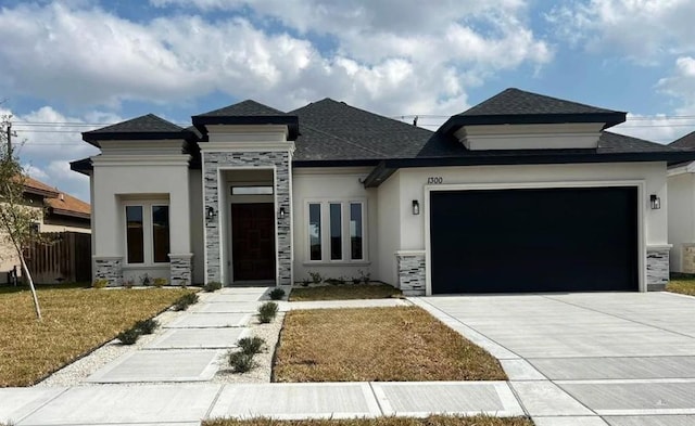 prairie-style home featuring a garage and a front yard