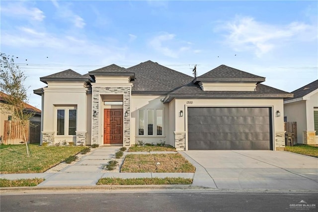 view of front of property featuring a garage and a front yard