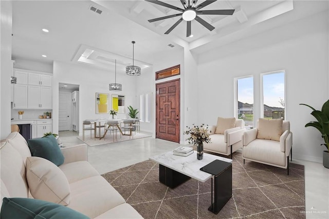 living area with beam ceiling, visible vents, recessed lighting, a ceiling fan, and a high ceiling