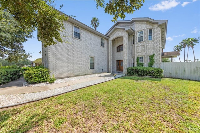 view of property featuring a front lawn