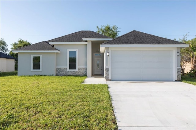 509 E Lorenzana St, Mercedes, TX 78570 - prairie-style house featuring stone siding, a garage, concrete driveway, a front lawn, and stucco siding