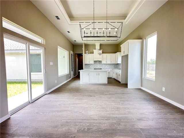 kitchen featuring light wood-type flooring, white cabinetry, a wealth of natural light, and track lighting