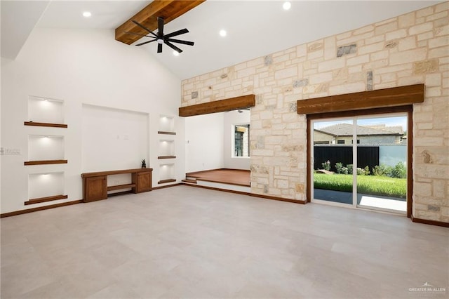 unfurnished living room with beamed ceiling, ceiling fan, and high vaulted ceiling