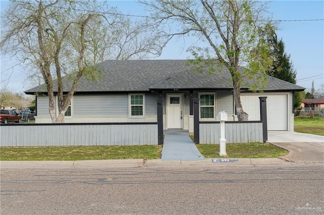 view of front of property with a fenced front yard, concrete driveway, a shingled roof, and an attached garage