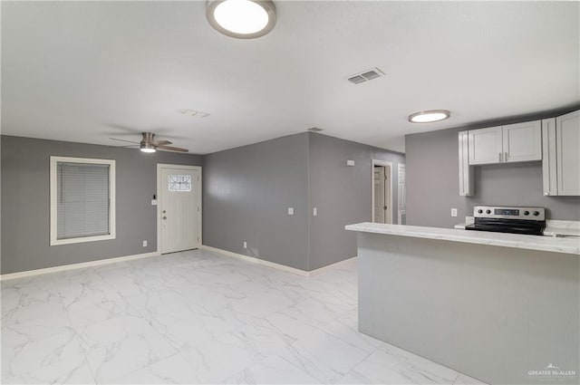 501 W Iowa St, Harlingen, TX 78552 - kitchen featuring visible vents, baseboards, light countertops, marble finish floor, and stainless steel electric range oven