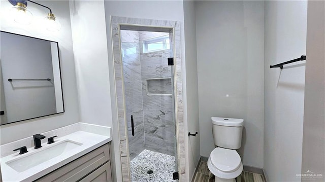 full bath with toilet, a stall shower, and vanity