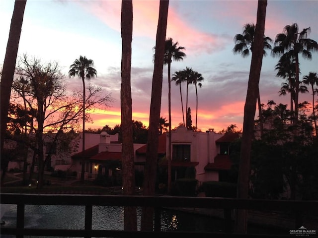 back house at dusk with a water view