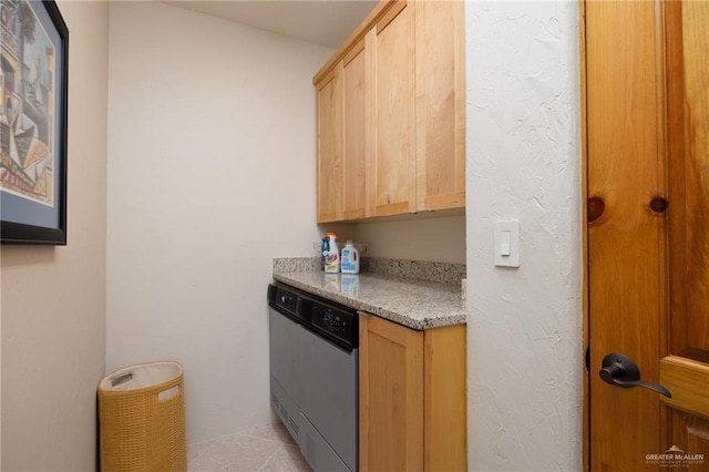 kitchen with light tile patterned flooring, dishwasher, and light brown cabinets