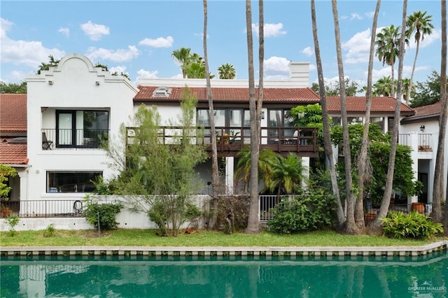 back of property with a balcony