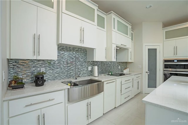 2008 S Erica St, Pharr, TX 78577 - kitchen featuring a sink, backsplash, light tile patterned flooring, double oven, and black electric stovetop