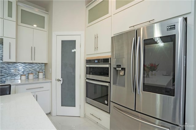 2008 S Erica St, Pharr, TX 78577 - kitchen featuring stainless steel appliances, light countertops, white cabinets, and backsplash