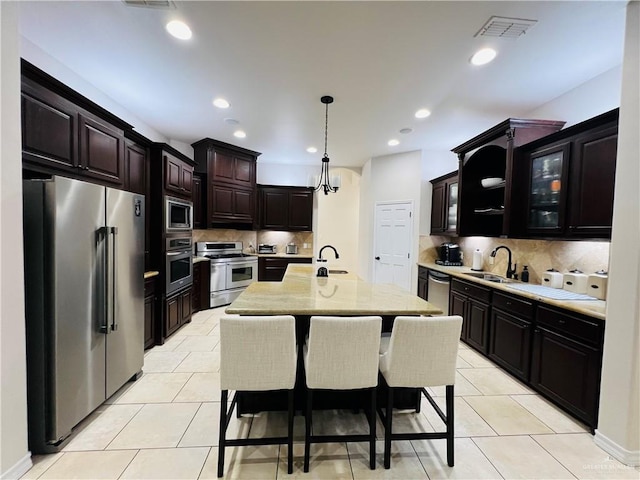 5809 N 3rd St, Mcallen, TX 78504 - kitchen featuring stainless steel appliances, a sink, backsplash, and recessed lighting