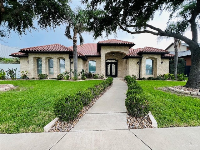 5809 N 3rd St, Mcallen, TX 78504 - mediterranean / spanish home featuring a tile roof, a front yard, and stone siding