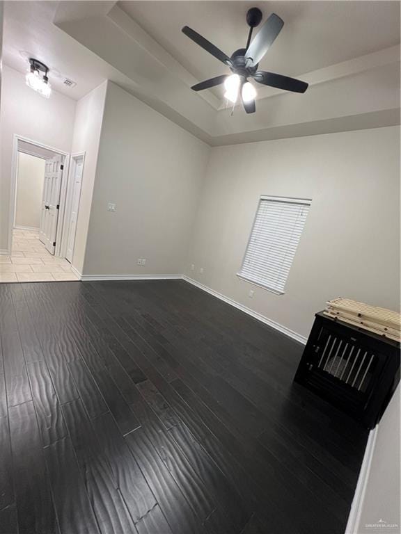5809 N 3rd St, Mcallen, TX 78504 - empty room featuring a raised ceiling, ceiling fan, baseboards, and wood finished floors