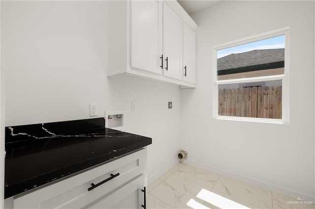 clothes washing area featuring hookup for a washing machine, cabinet space, baseboards, and marble finish floor