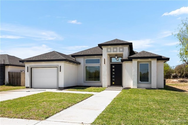 prairie-style home featuring a front yard, fence, stucco siding, concrete driveway, and a garage