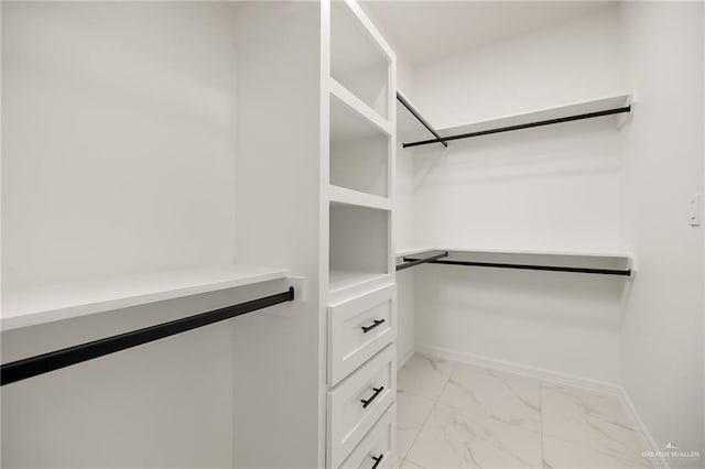 spacious closet with marble finish floor