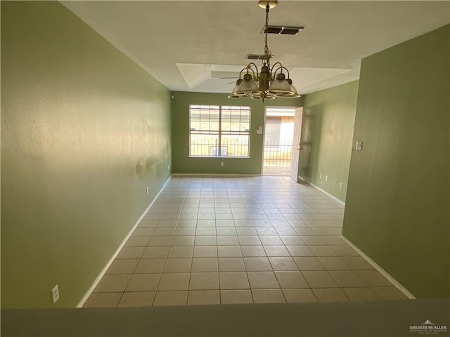 unfurnished room with light tile patterned floors and a chandelier