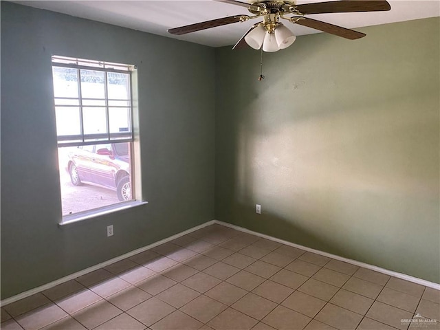 tiled empty room with ceiling fan