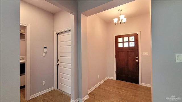 foyer featuring light hardwood / wood-style floors and an inviting chandelier