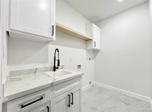 clothes washing area featuring electric dryer hookup, hookup for a washing machine, sink, and cabinets