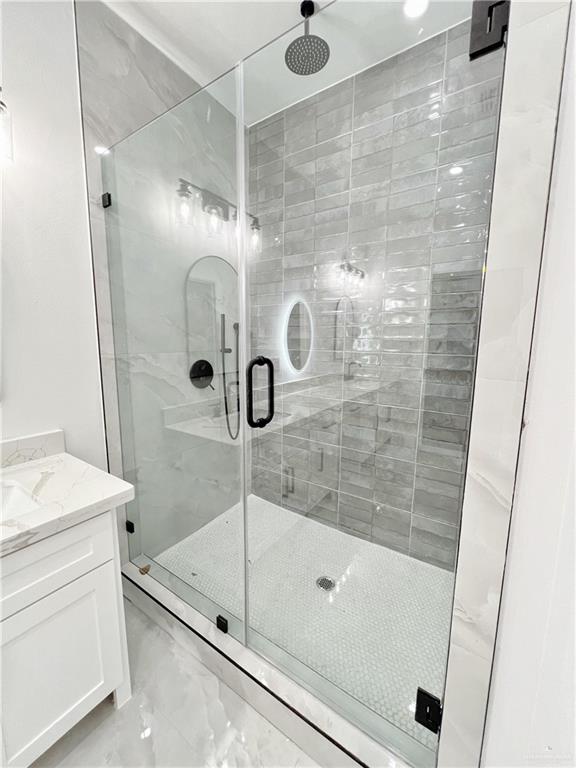 bathroom featuring vanity and an enclosed shower