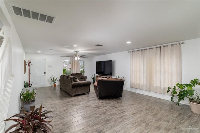 living room with hardwood / wood-style floors and ceiling fan