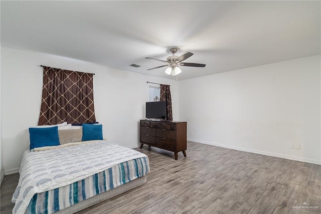 bedroom with hardwood / wood-style floors and ceiling fan