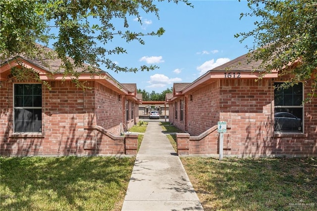 1612 Tampa St, Edinburg, TX 78541 - view of home's exterior with brick siding and a lawn
