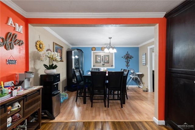 1914 W Barcelona Ave, Harlingen, TX 78550 - dining area featuring baseboards, wood finished floors, a notable chandelier, and ornamental molding